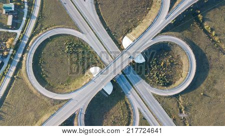 Aerial shot of highway junction with cars top view in the form of a sign of infinity.