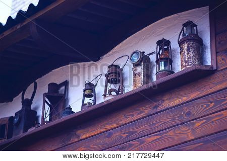 Vintage oil lantern lamps on an antique rustic wall.