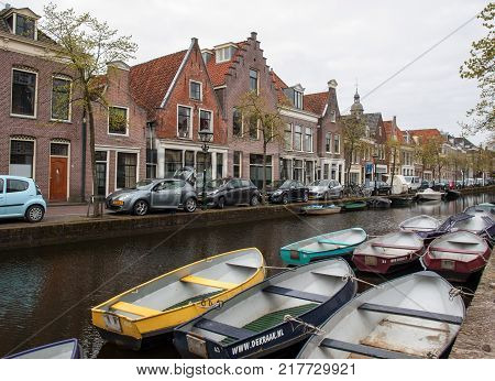 ALKMAAR NETHERLANDS - APRIL 21 2017: Historic old town of Alkmaar North Holland Netherlands typical canal houses