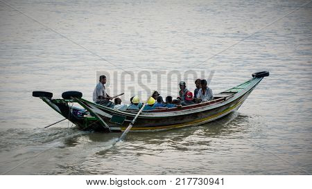 boat passengers in Hlaing river, they are going to opposite site of Hlaing river, Yangon, Myanmar, April-2017