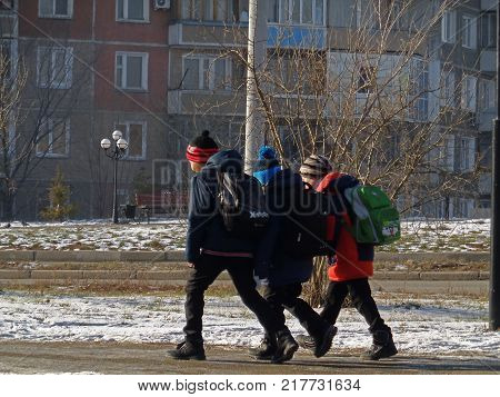 Kazakhstan, Ust-Kamenogorsk - 2 December , 2017. Children walking on Komsomolskaya street.