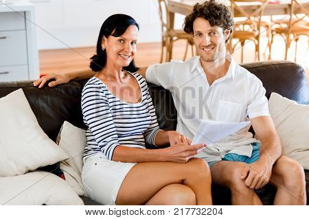 Couple with papers in their living room