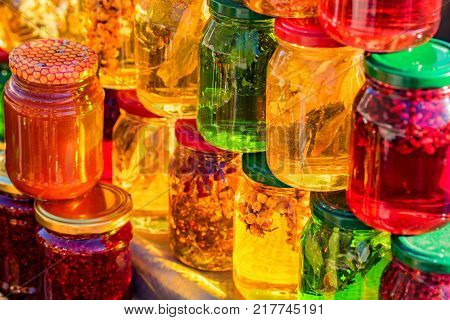 Glass jars with different sorts of honey in Russian marketplace