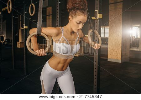 Workout On  Rings Fitness Woman The In Gym. Fit Power Athletic Confident Young Woman Crossfi