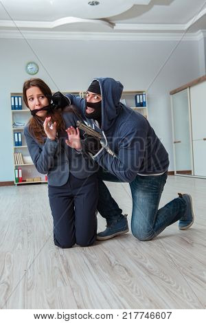 Criminal taking businesswoman as hostage in office