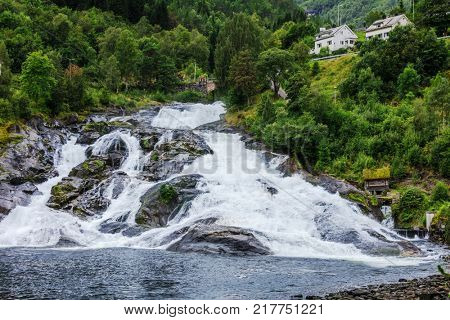 Hellesyltfossen waterfall in the area Geirangerfjord in village Hellesylt