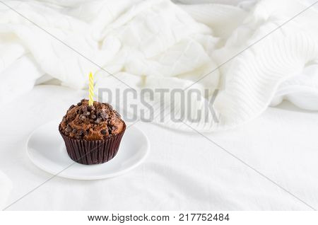 Birthday muffins or capkakes with chocolate on a wooden tray in bed. White background. Sweet food. Festive mood copy space flat lay