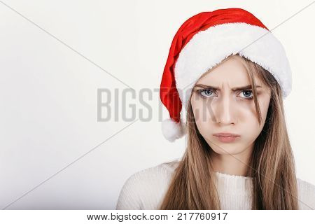The Young Woman In Santa Hat With Bad Mood Make Capricious Face