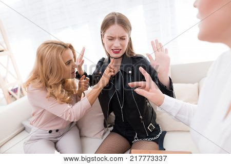 A teenage girl with her mother at a psychologist's reception. The girl has a complicated character. She does not listen to adults. She loves rock music and dressed in a leather jacket.