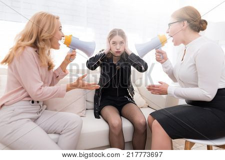 A teenage girl with her mother at a psychologist's reception. The girl has a complicated character. She does not listen to adults. She loves rock music and dressed in a leather jacket.