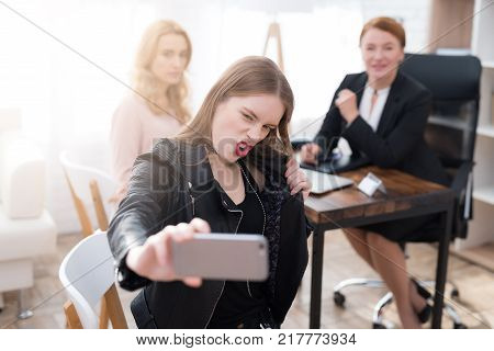 A teenage girl with her mother at a psychologist's reception. The girl has a complicated character. She does not listen to adults. She loves rock music and dressed in a leather jacket.