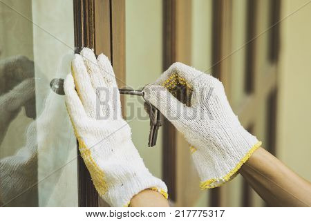 Burglar with passkey tools breaking and entering into a house