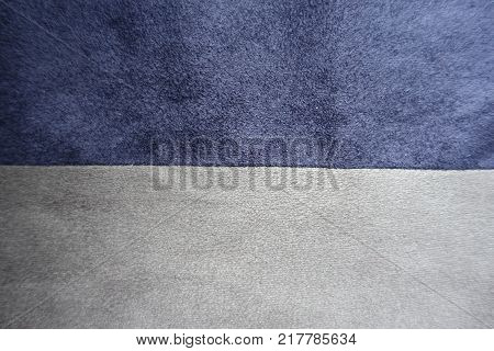 Pieces of blue and grey artificial suede sewn together horizontally