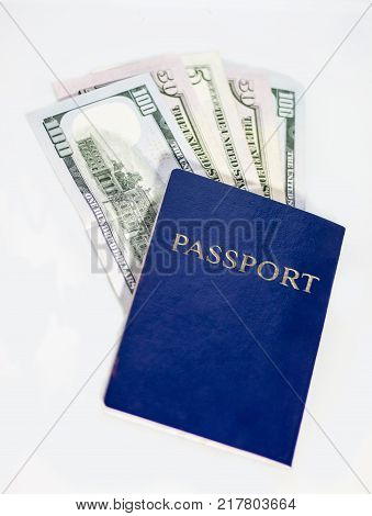 Dollars in blue passport on white background. close-up