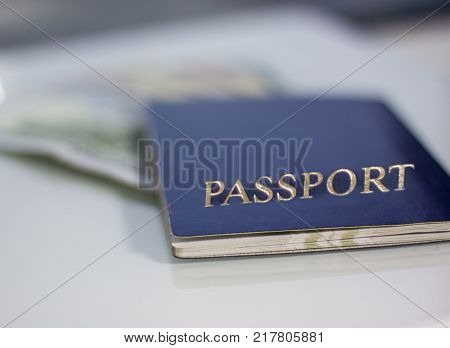 Dollars in blue passport on white background. close-up