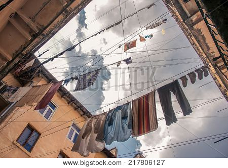 T-shirts and other clothes on the rope in the old yard.