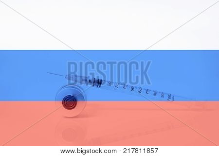 Medical syringe with doping against the background of the flag of Russia. Concept of doping in sport