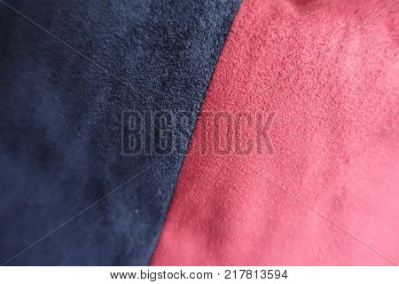Pieces of dark blue and red artificial suede sewn together