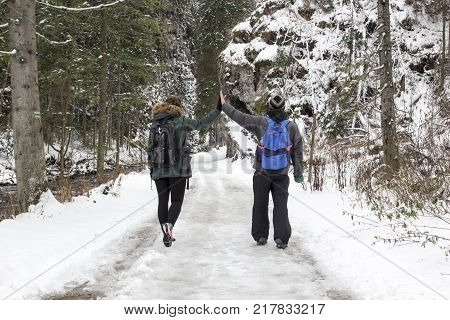 A couple walks through a mountain gorge