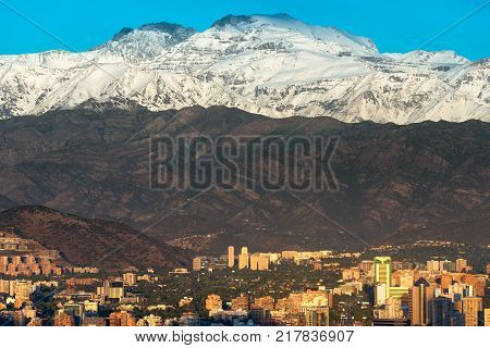 Buildings at Las Condes district in Santiago de Chile and Los Andes mountain range.