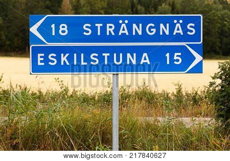 Signpost with distances to the Swedish cities Strangnas and Eskilstuna.