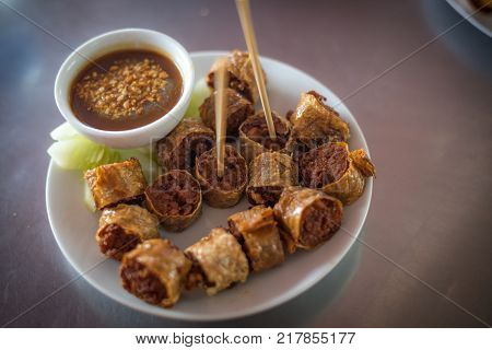 Deep Fried Crab and chicken meat roll (Hoi Jo) in a white plate southern style food of Thailand