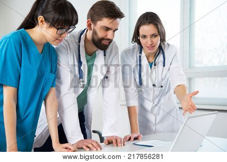 Group of doctors in the hospital discuss the diagnos of the patient