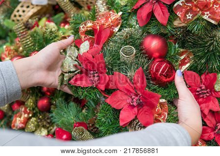 Closeup view of customer choosing Christmas decorations. Various choice of New Year's wreath with decorations