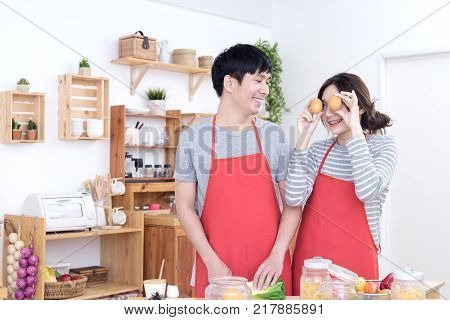Young asian lover or couple cooking very funny happy and joyful together in kitchen. Lifestyle lover at home concept.