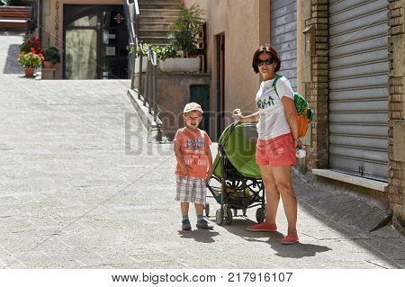 San Marino, San Marino - July 10, 2017: Tourists Mother And Son Walk The Streets Of San Marino.
