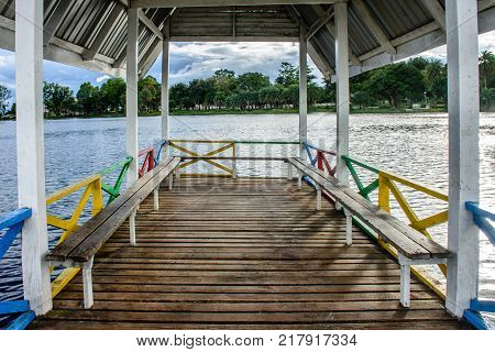 landscape photo of wooden bench on the lake