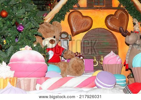 VOLGOGRAD RUSSIA - December 07 2017: The festive New Year's toy lodge near gifts toys and a fir-tree decorates the foyer 