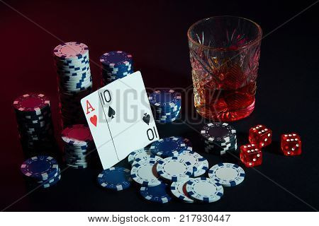 Poker cards with cubes are beautifully placed on the table, against the background of poker chips. Still life. The concept of gambling. Poker Online. Cards - ace and ten