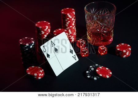 Cards of poker player. On the table are chips and a glass of cocktail with whiskey. Still life. The concept of gambling. Poker Online. Cards - Ace and jack