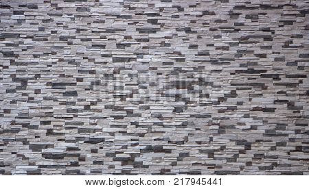 Decorative brick wall from concrete facing tiles as background or texture.