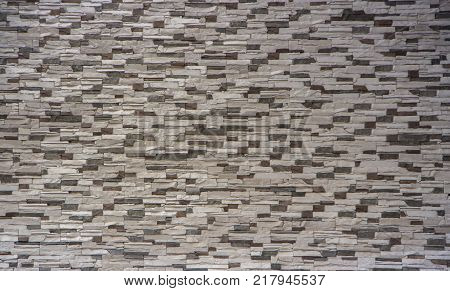 Decorative brick wall from concrete facing tiles as background or texture.