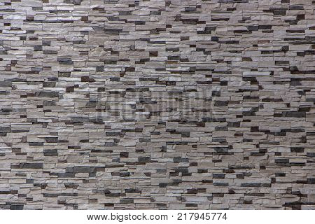 Decorative brick wall from concrete facing tiles as background or texture.