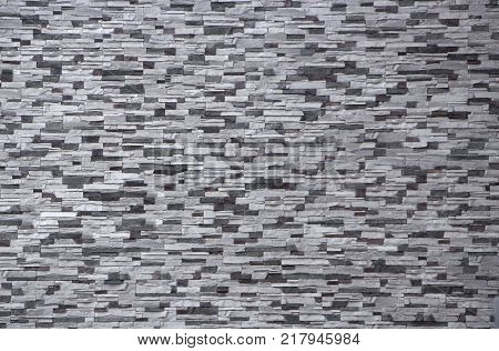 Decorative brick wall from concrete facing tiles as background or texture.