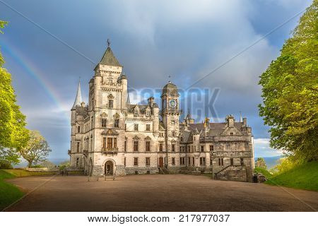 Spectacular rainbow in the dramatic sky at the scenic Dunrobin Castle in Scotland. Northern Highlands in Golspie, the east coast of Scotland, United Kingdom.