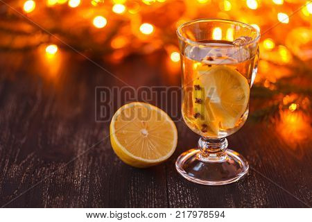 easonal and holidays concept. Christmas and autumn theme. One glasses mulled wine on a rustic wooden table. Selective focus