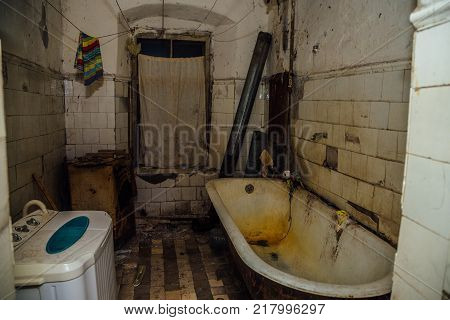 Dirty messy bathroom is in the poor  apartment in old emergency house.