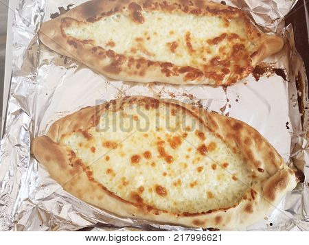 Adjarian khachapuri, open bread stuffed with cheese and egg yolk. Khachapuri is a traditional dish of Georgian cuisine.