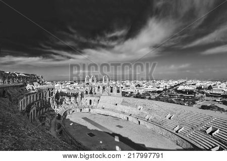 El Djem Amphitheatre in Tunisia. Part with arches of roman biggest amphitheater in africa, monochrome