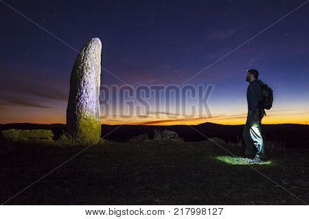 Trekker getting close to Radish Menhir or Menhir del Rabano. Badajoz Spain Valencia del Ventoso