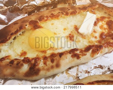 Adjarian khachapuri, open bread stuffed with cheese and egg yolk. Khachapuri is a traditional dish of Georgian cuisine.