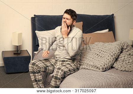 Get Up Early. Tips For Waking Up Early. Man Bearded Hipster Sleepy Face Pajamas Waking Up Bedroom In