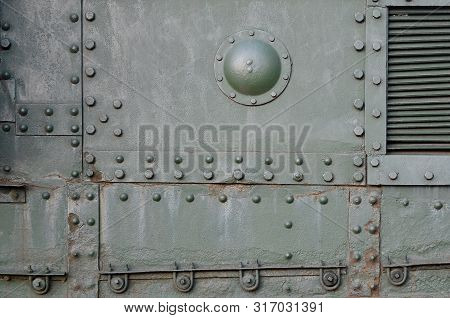 Texture Of Tank Side Wall, Made Of Metal And Reinforced With A Multitude Of Bolts And Rivets