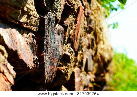 Ancient Wall Made Of Large Stones Of Iron Ore Bonded.