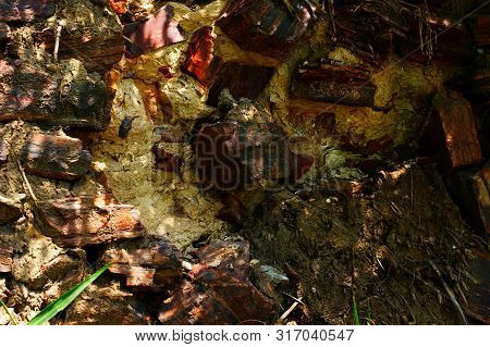 Old Wall Made Of Large Stones Of Iron Ore Bonded By Sand.