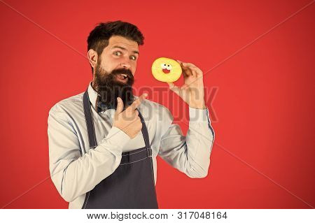 Cheat Meal. Hipster Bearded Baker Hold Glazed Donut On Red Background. Cafe And Bakery Concept. Swee